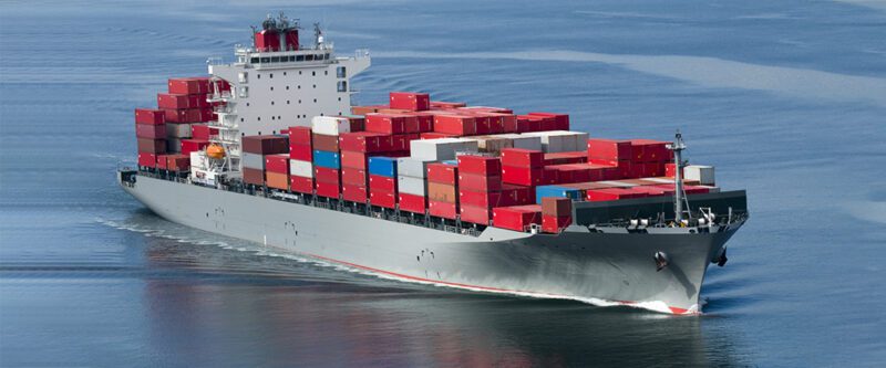 Marine Insurance - Image of container ship at sea with mostly red containers